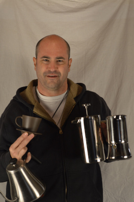 Picture of me with a whole bunch of coffee making equipment.